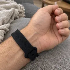 Adam K.'s photo: the band on his wrist, his arm resting on a grey sofa.