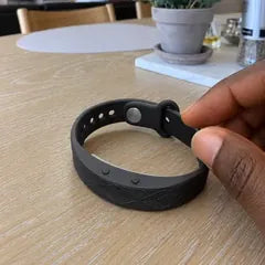 Tyler N.'s photo: the band on a kitchen table, his fingers on its strap.