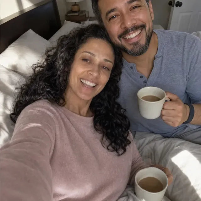 After: she and her husband smile in bed at 6:30, each with a coffee.