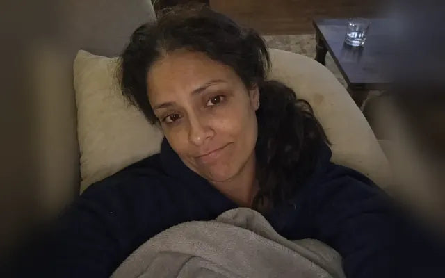 Before: she lies awake on the couch under a blanket at 5:00, worn out.