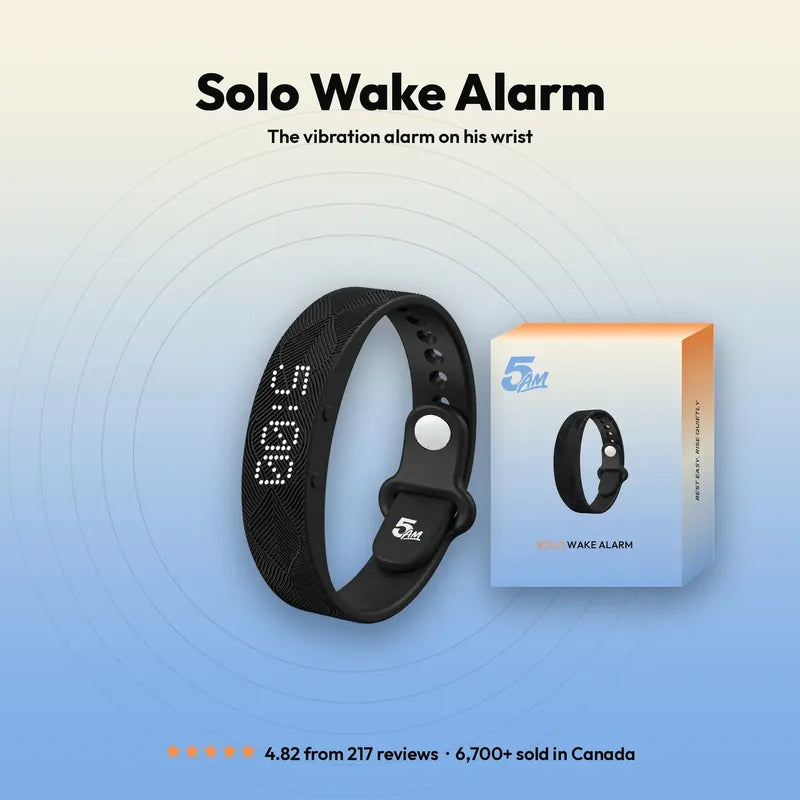 Solo Wake Alarm: the black vibration band with its screen lit, 5:00, and its box beside it.