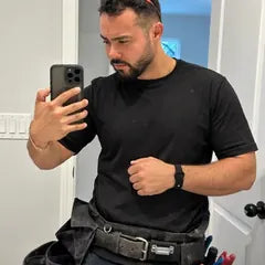 Ben L.'s photo: a mirror selfie in his tool belt, safety glasses on his head, the band on his wrist.