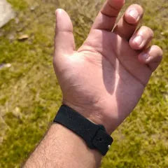 Rob D.'s photo: the band on his wrist outdoors, his hand open over the grass.